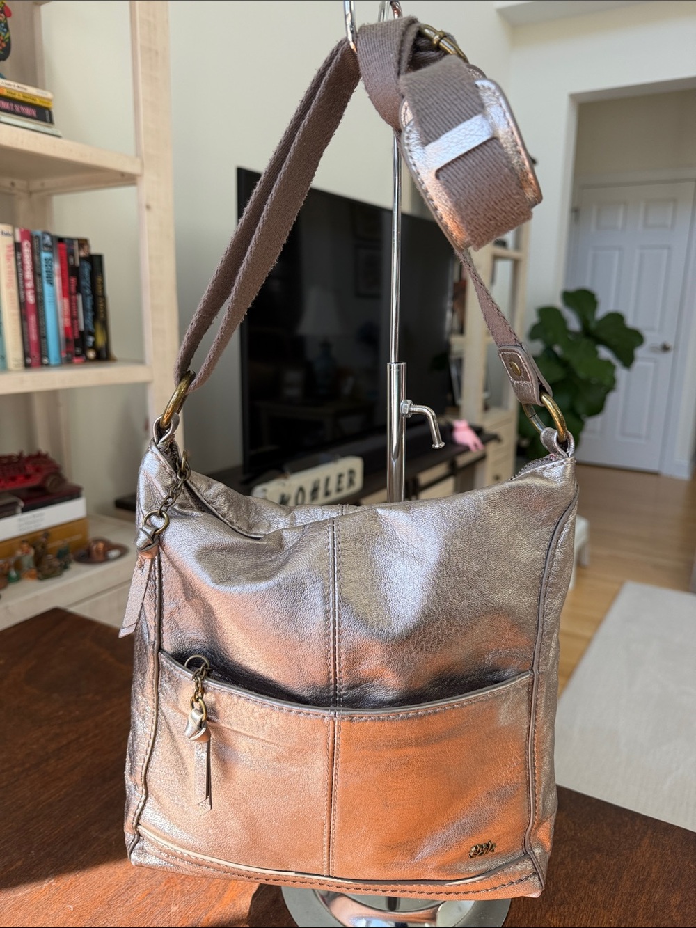 The Sak gold metallic leather messenger bag w/guitar strap